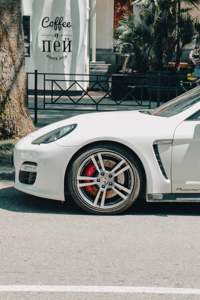 a white sports car parked on the side of the road