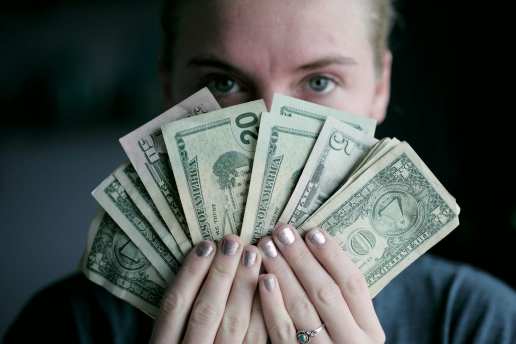 Home 3 person holding fan of U.S. dollars banknote